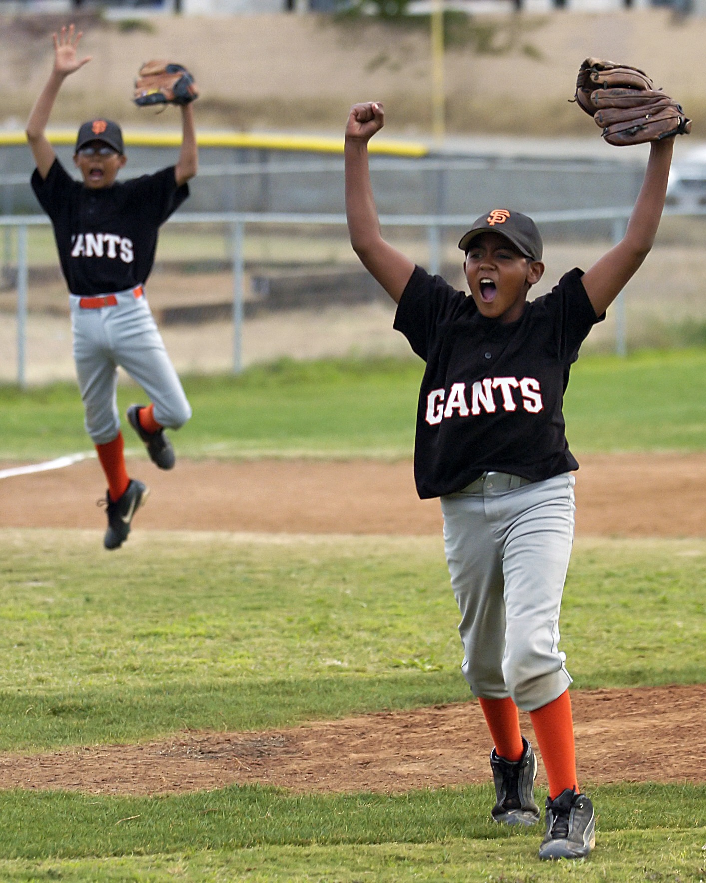 Youth baseball players celebrating on the field