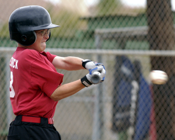 Youth baseball batter making contact with the ball